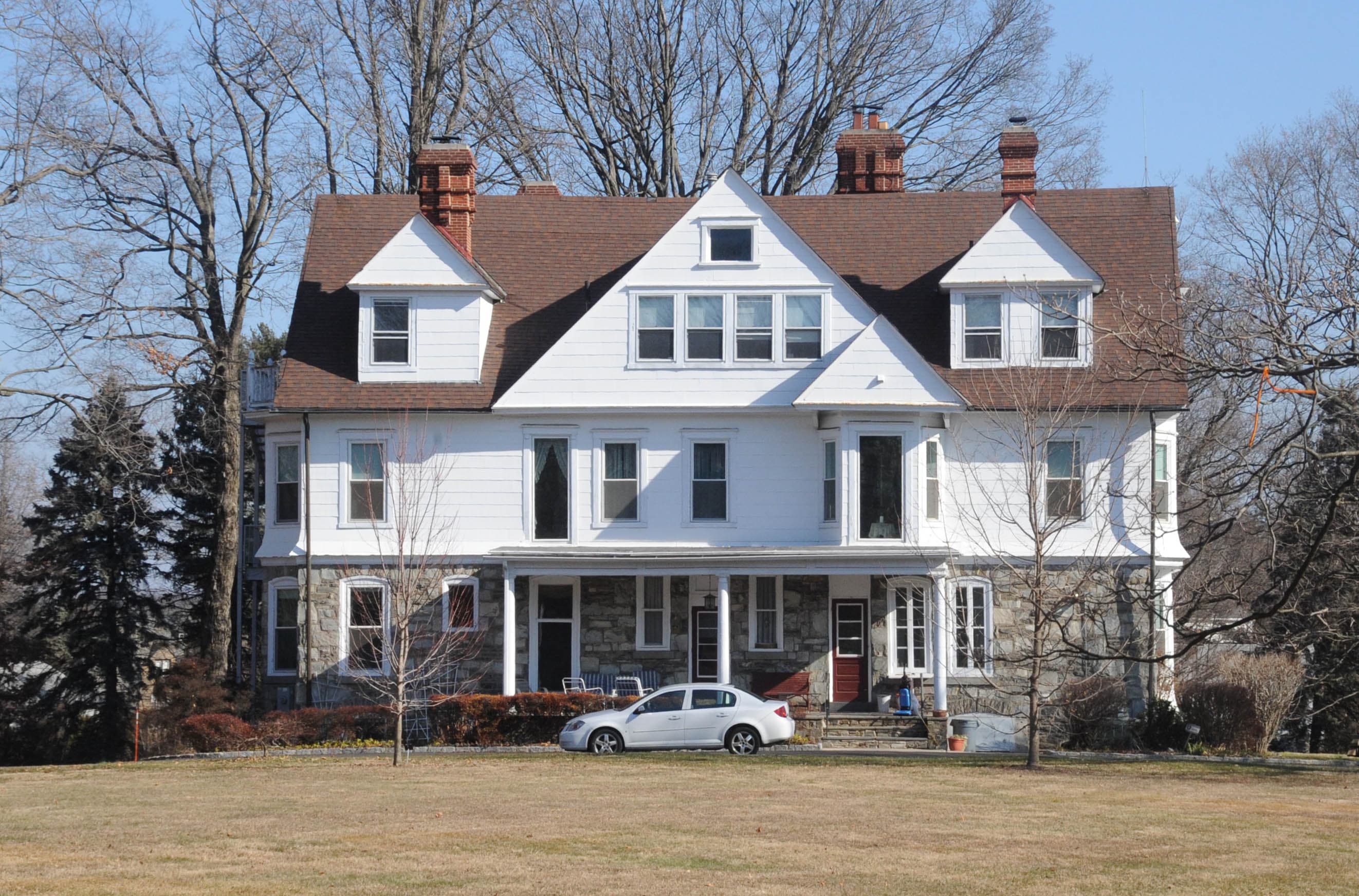 Mill-Rae, a large white shingled house with dormers and a stone porch, on high ground in the Somerton section of northeast Philadelphia.