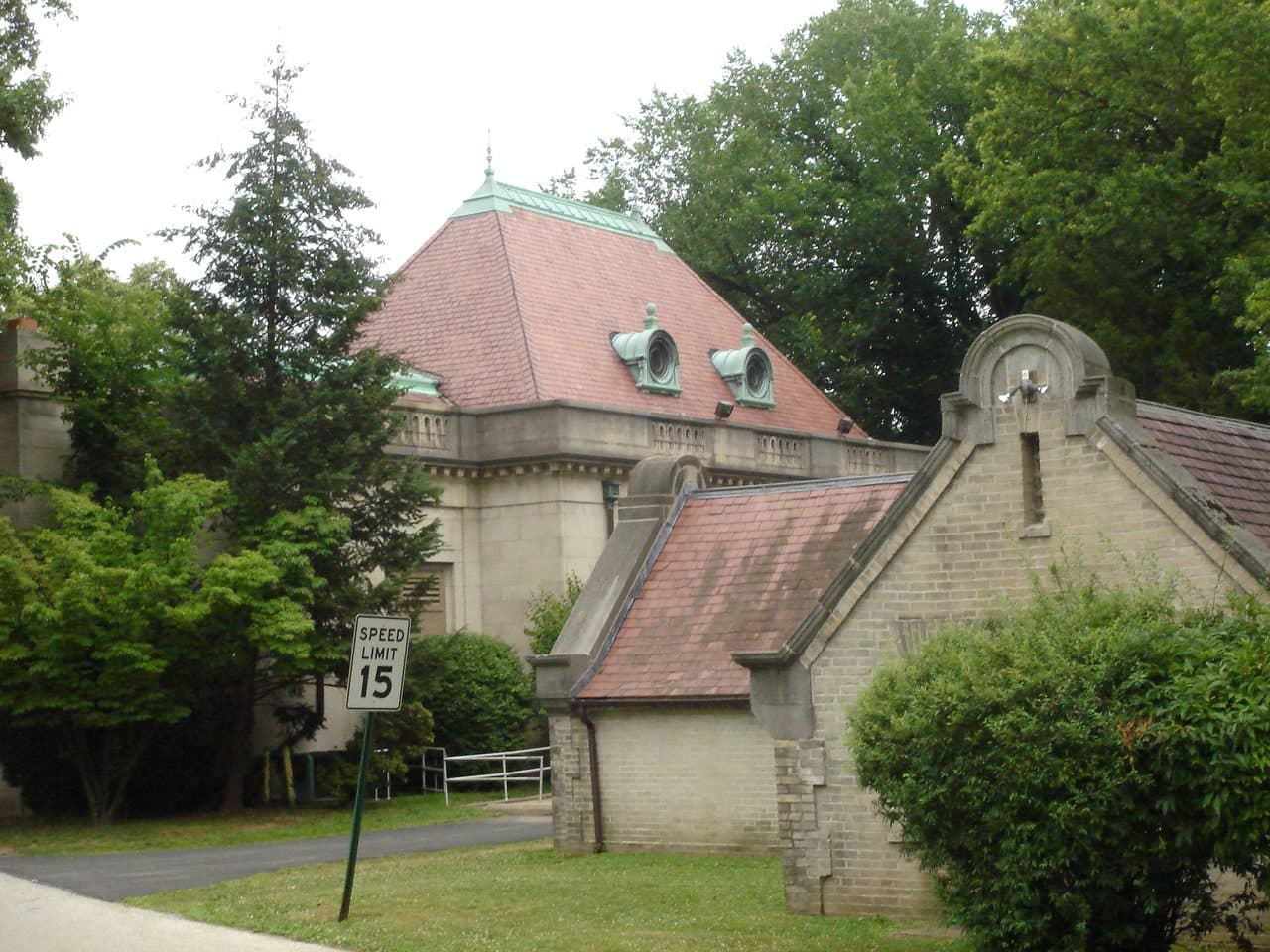 Curtis Hall at the Curtis Arboretum in Elkins Park, Pennsylvania, a domed stone building with an arched gateway seen from the drive.