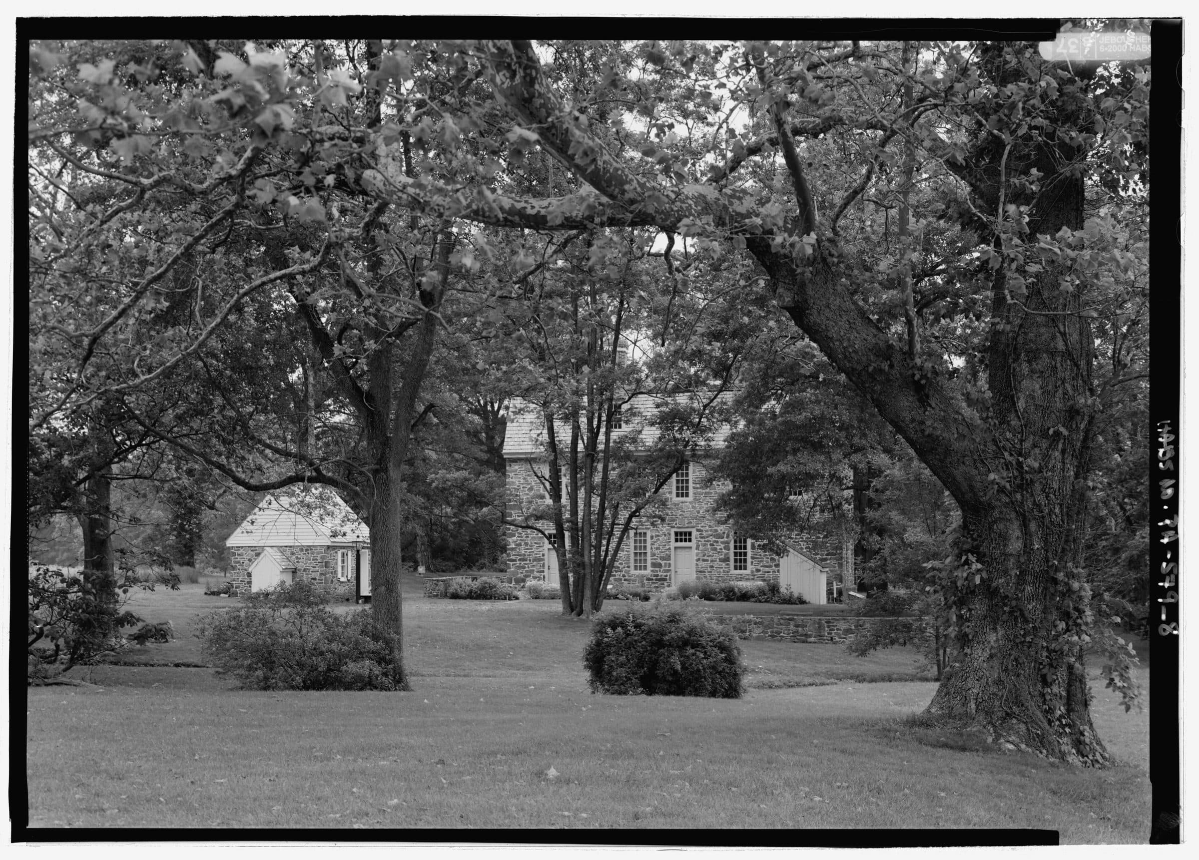 Graeme Park in Horsham, Pennsylvania — the 1722 stone Keith House seen across its pond and a rail fence, in a black and white architectural survey photograph.
