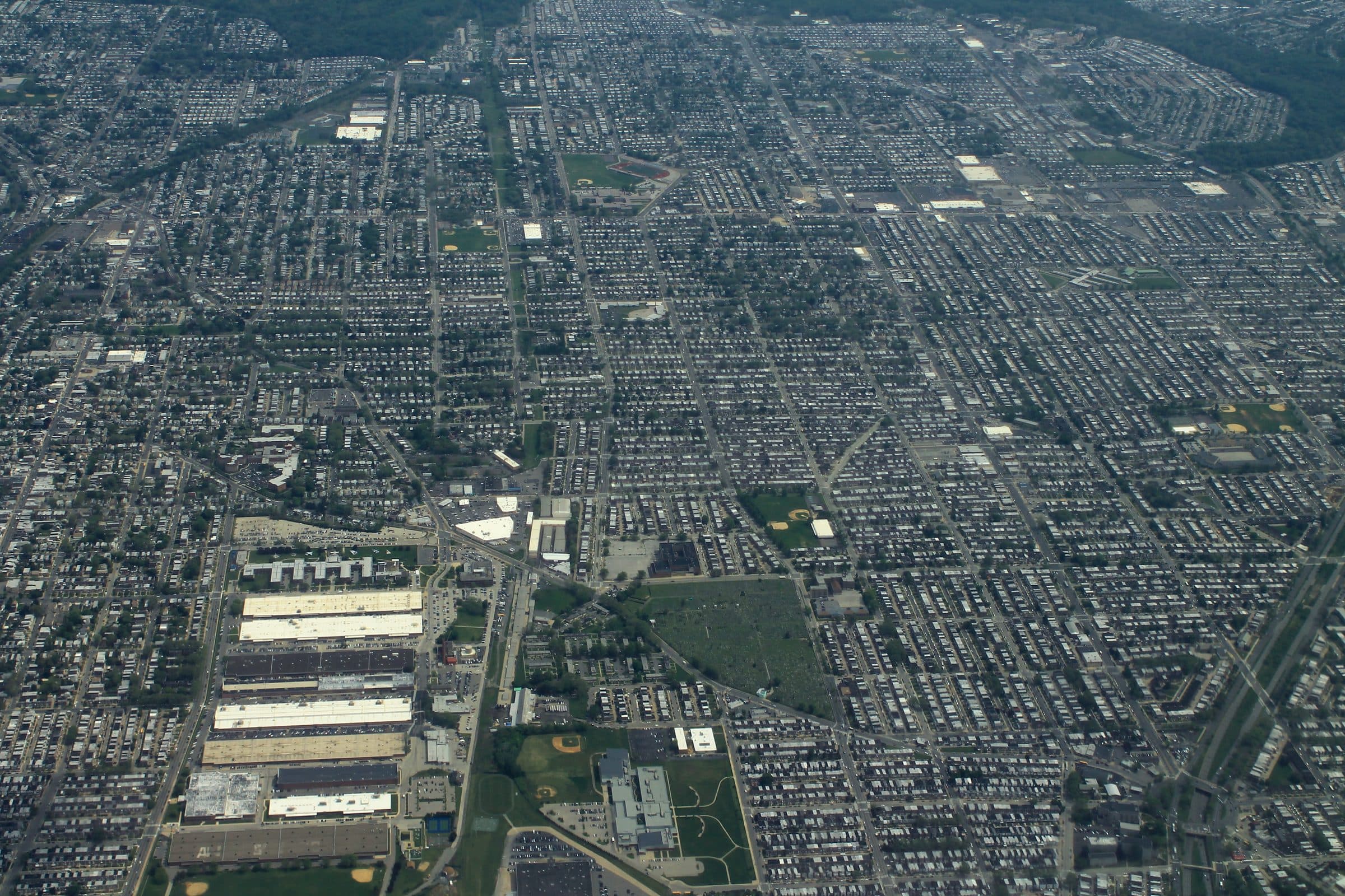 An aerial view over the Oxford Circle and Lawncrest sections of northeast Philadelphia, showing block after block of rowhouses laid out on a grid.