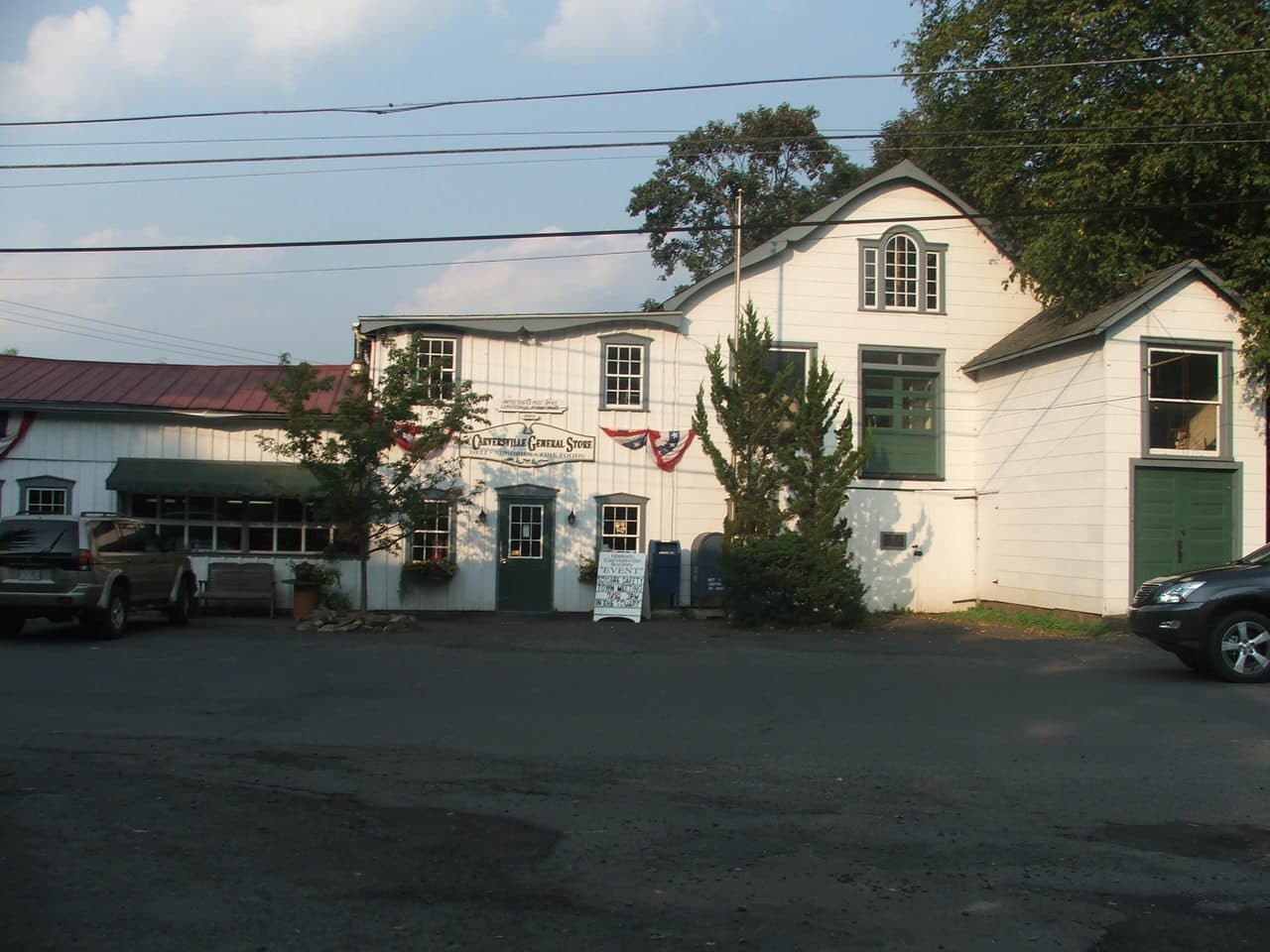 The Carversville General Store, a white clapboard building with a porch and a gravel forecourt, in the village of Carversville, Pennsylvania.