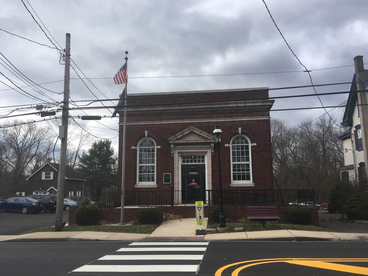 Chalfont Borough Hall in Chalfont, Pennsylvania, a small red-brick civic building with arched windows and a flagpole out front.