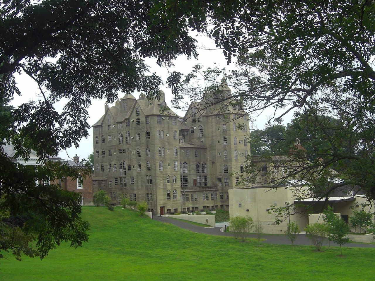 The Mercer Museum in Doylestown, Pennsylvania, a six-story castle of poured concrete with gabled towers, seen across a lawn.