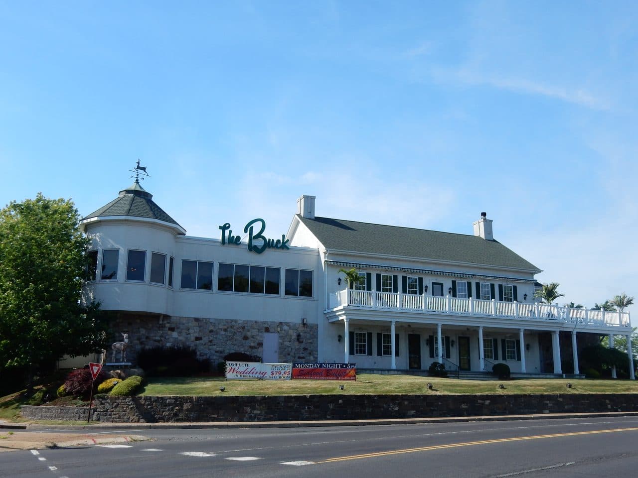 The Buck Hotel on Bustleton Pike in Feasterville, Pennsylvania, a white two-story building with a round tower and a deer weathervane.
