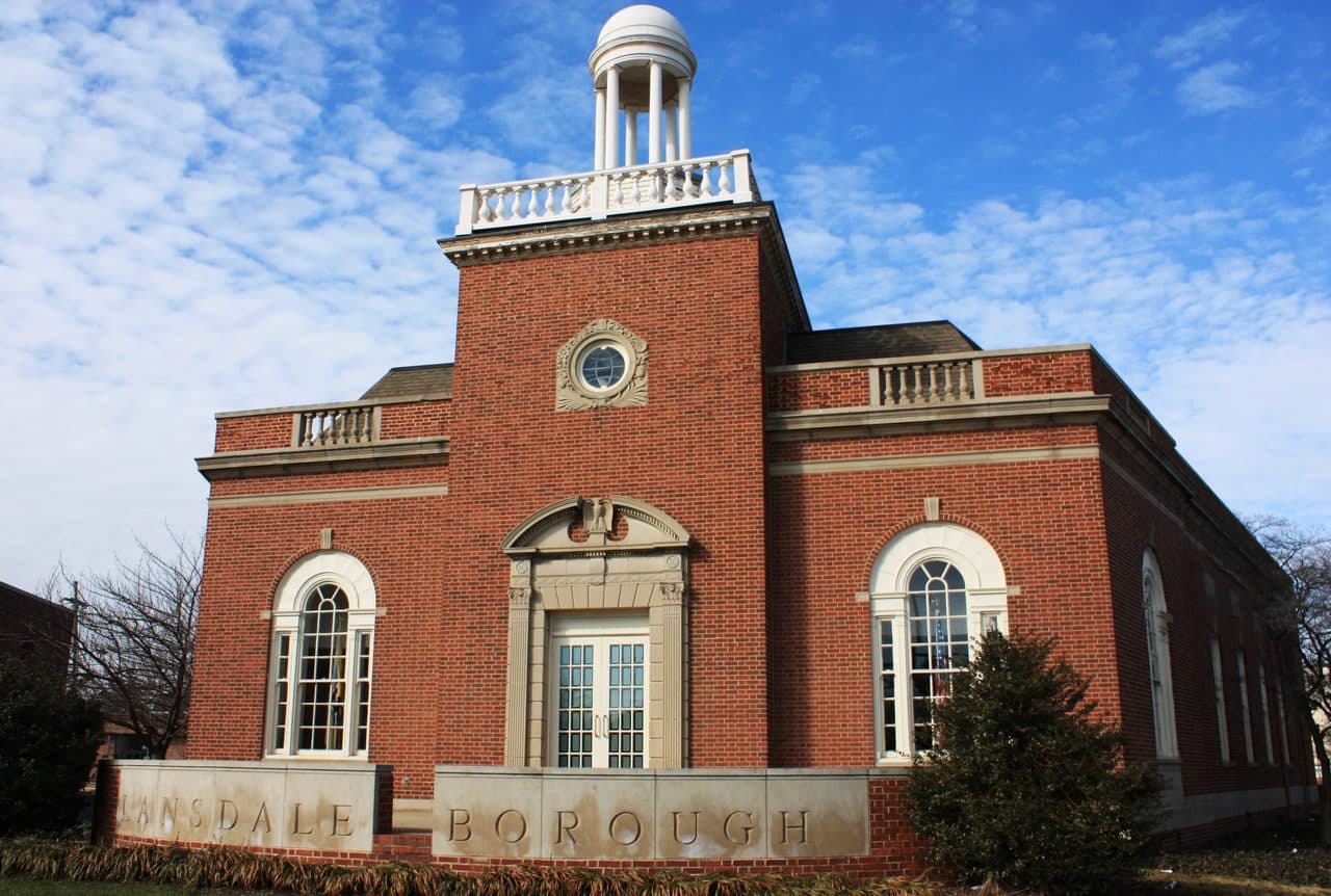 Lansdale Borough Hall in Montgomery County, Pennsylvania, a red-brick civic building with arched windows and a white cupola.