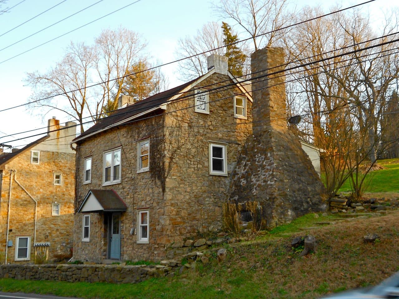A fieldstone house with a large exterior chimney in the Spring Valley Historic District, Buckingham Township, Bucks County, Pennsylvania.