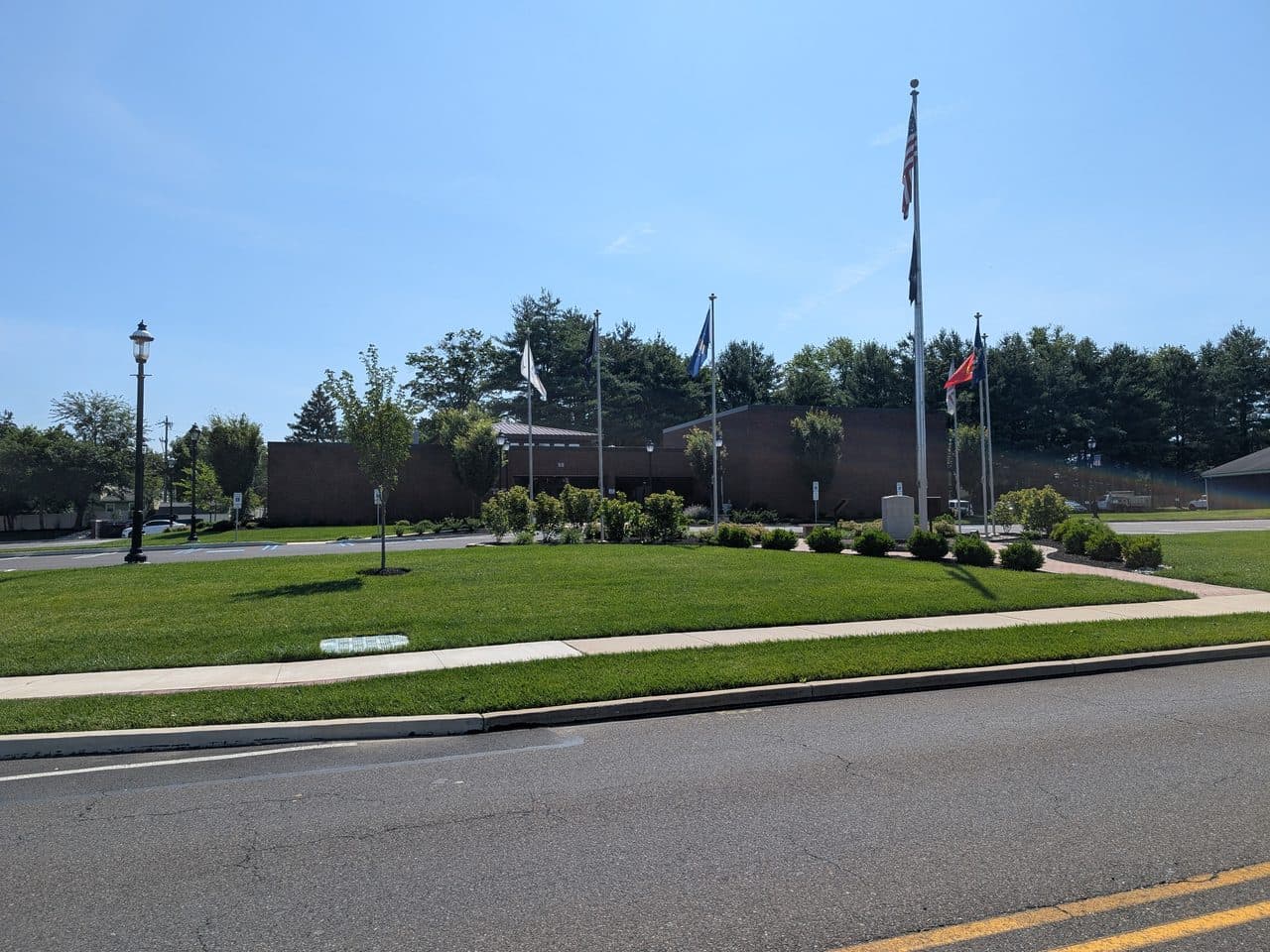 The Northampton Township municipal building in Richboro, Pennsylvania, a low brick building behind a lawn and a row of flagpoles.